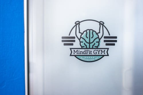 MindFit Gym logo printed on glass window