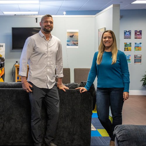 MindFit owners Dr Rob Rice and Julie Cenzi standing by the game section of MindFit office.